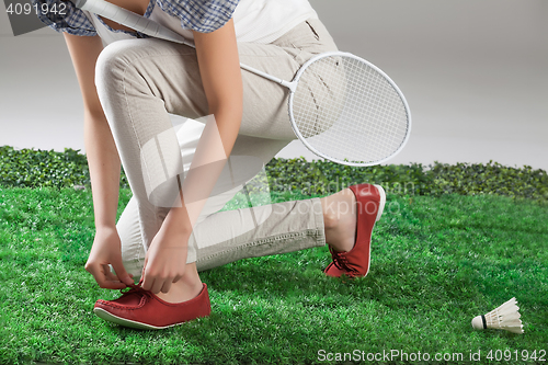 Image of Woman\'s Legs And Badminton Racket