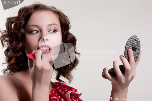 Image of Young Woman Applying Cosmetics