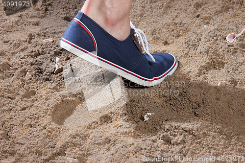 Image of Man\'s Legs And Footprint On The Sand