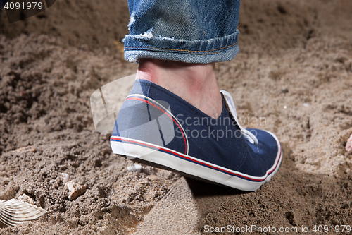 Image of Man\'s Legs And Footprint On The Sand