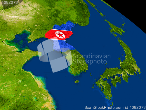 Image of North Korea with flag on Earth