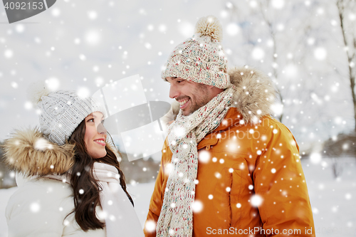 Image of happy couple walking over winter background