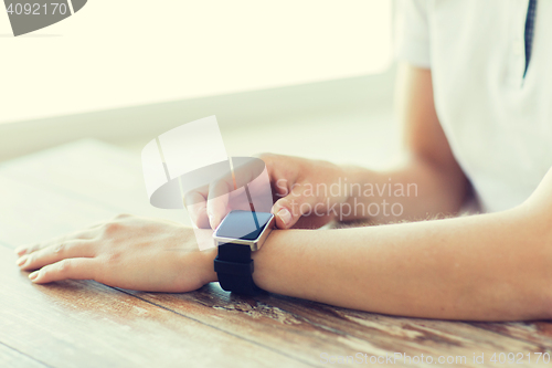 Image of close up of hands setting smart watch