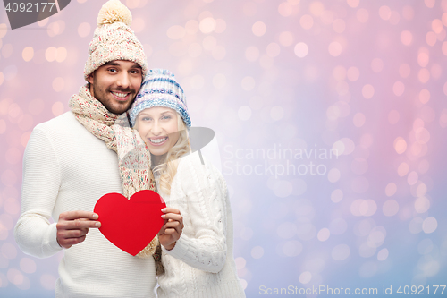 Image of smiling couple in winter clothes with red hearts