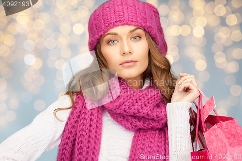 Image of happy woman in winter clothes with shopping bags