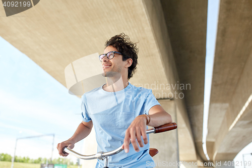 Image of young hipster man riding fixed gear bike