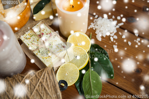 Image of natural soap and candles on wood