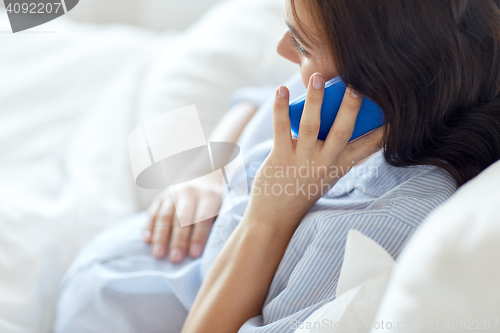 Image of close up of pregnant woman calling on smartphone