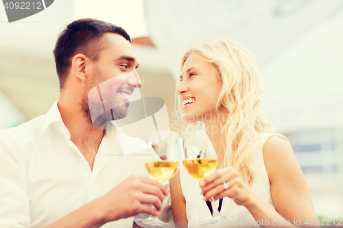 Image of happy couple clinking glasses at restaurant lounge