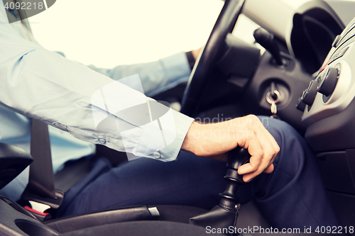 Image of close up of young man driving car