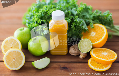 Image of bottle with orange juice, fruits and vegetables