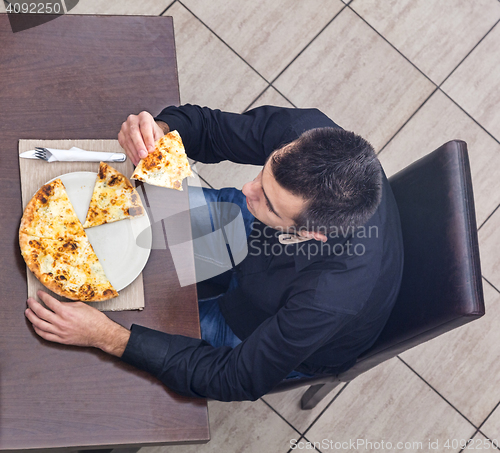 Image of Young Man Eating Pizza