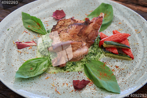 Image of cooked rabbit meat with spinach and raisins