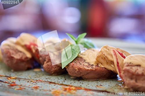 Image of Close up of grilled chicken breast under cream and milky cheese sauce