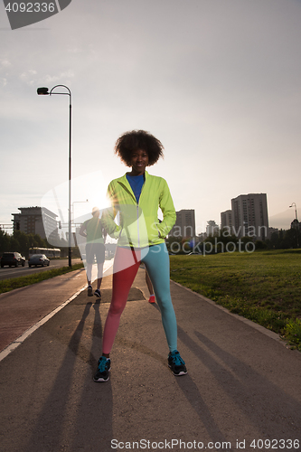 Image of Portrait of sporty young african american woman running outdoors