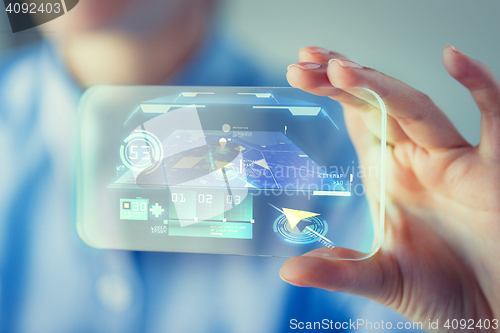 Image of close up of woman with transparent smartphone