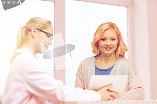 Image of doctor with tablet pc and woman at hospital