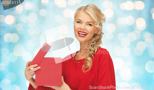 Image of happy smiling woman in red dress with gift box