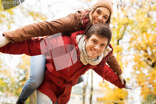 Image of happy young couple having fun in autumn park