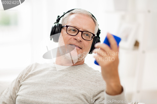 Image of happy senior man with smartphone and headphones