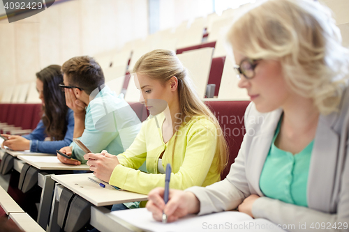 Image of student girl with smartphone at lecture