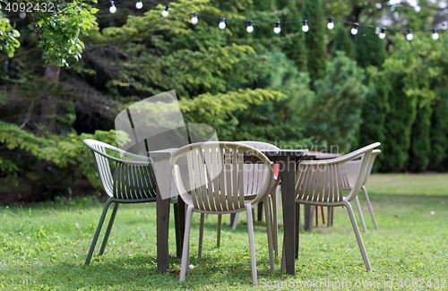 Image of table with chairs at summer garden