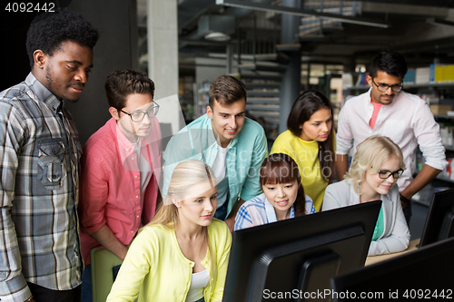 Image of international students with computers at library