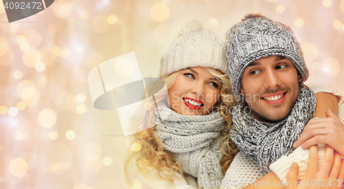 Image of happy family couple in winter clothes hugging