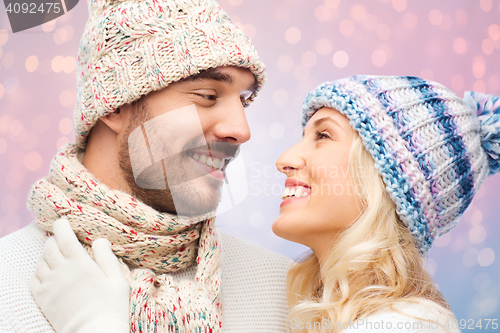 Image of smiling couple in winter clothes hugging