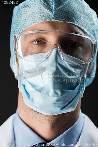 Image of close up of scientist in goggles, mask and hat