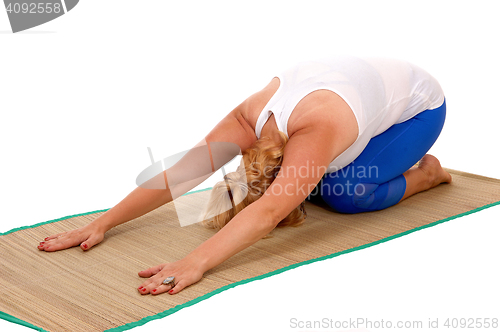 Image of Yoga trainer kneeling on stomach.