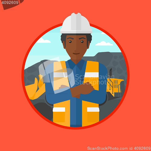 Image of Miner with a big excavator on background.