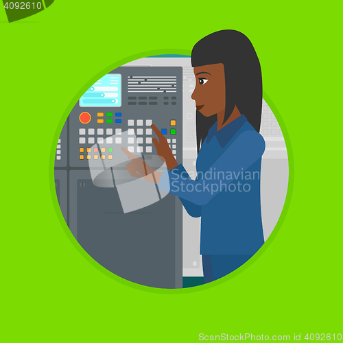 Image of Engineer standing near control panel.