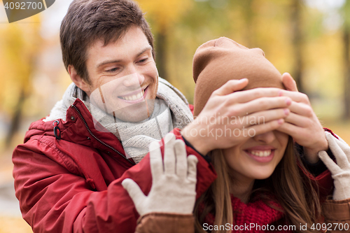 Image of happy young couple having fun in autumn park