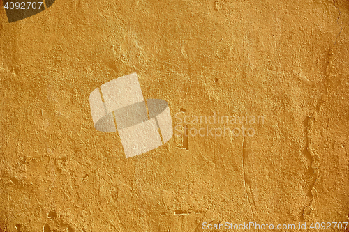 Image of yellow painted stone wall surface