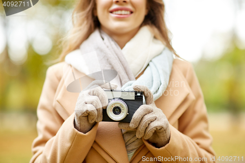 Image of close up of woman with camera in autumn park