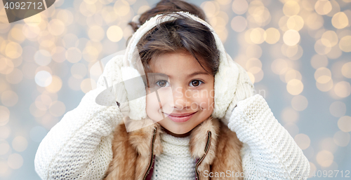 Image of happy little girl wearing earmuffs