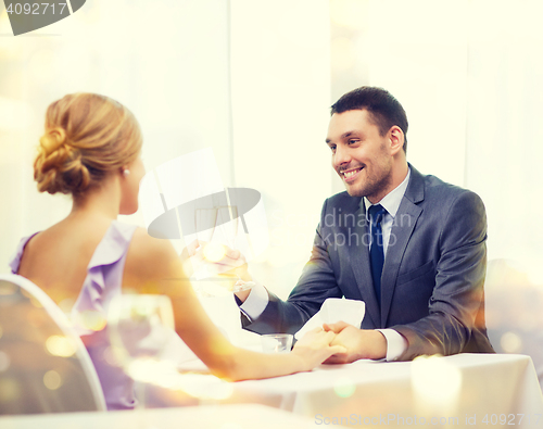 Image of couple with glasses of champagne at restaurant