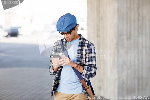 Image of hipster man texting message on smartphone