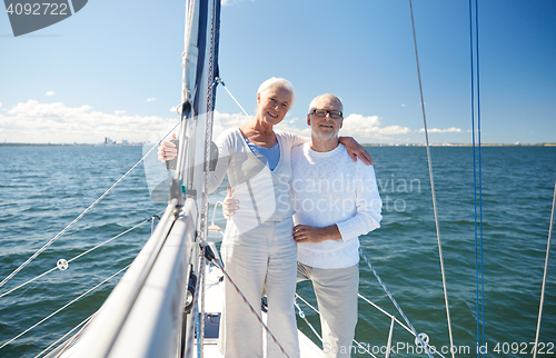 Image of senior couple hugging on sail boat or yacht in sea