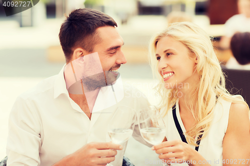 Image of happy couple clinking glasses at restaurant lounge