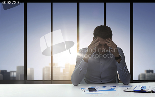 Image of close up of anxious businessman with papers