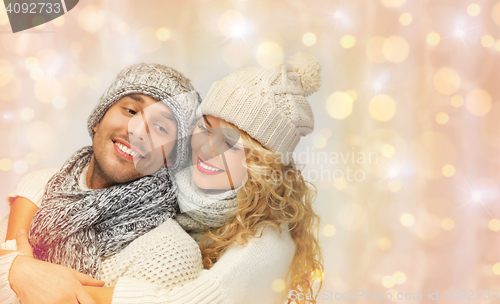 Image of happy family couple in winter clothes hugging