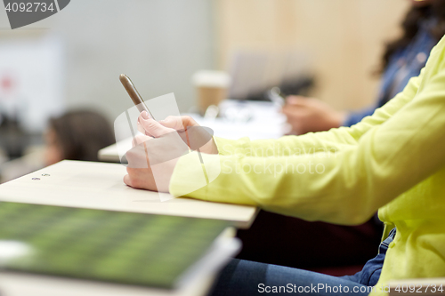 Image of close up of student with smartphones on lecture