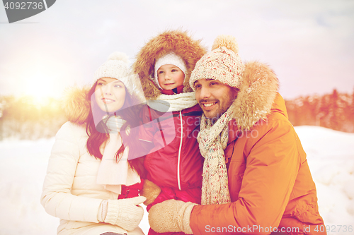 Image of happy family with child in winter clothes outdoors