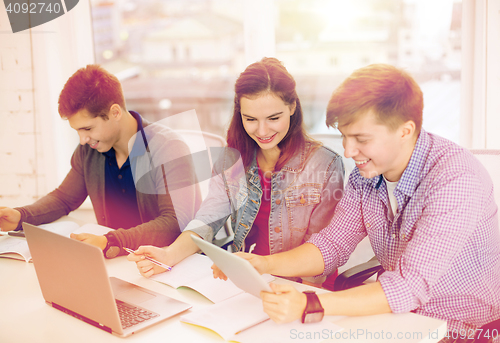 Image of students with laptop, notebooks and tablet pc