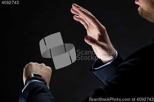 Image of close up of businessman hands with smart watch