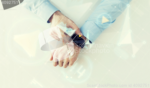 Image of hand with smartwatch and virtual screen projection