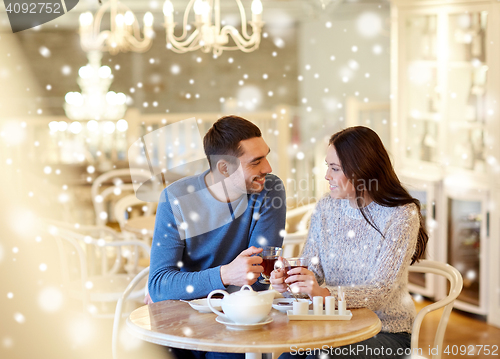 Image of happy couple drinking tea at cafe