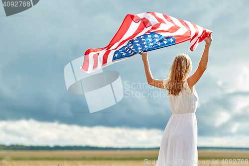 Image of happy woman with american flag on cereal field